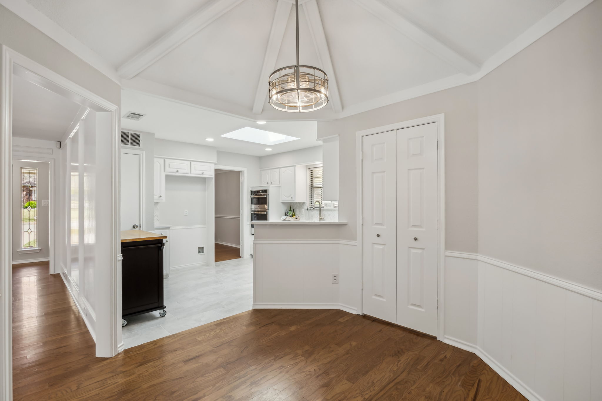 Here is a view from, the Breakfast Area into the kitchen - to the left is a view of the front entry!  The Laundry room is convenientlhy tucked neatly behind the two doors!
