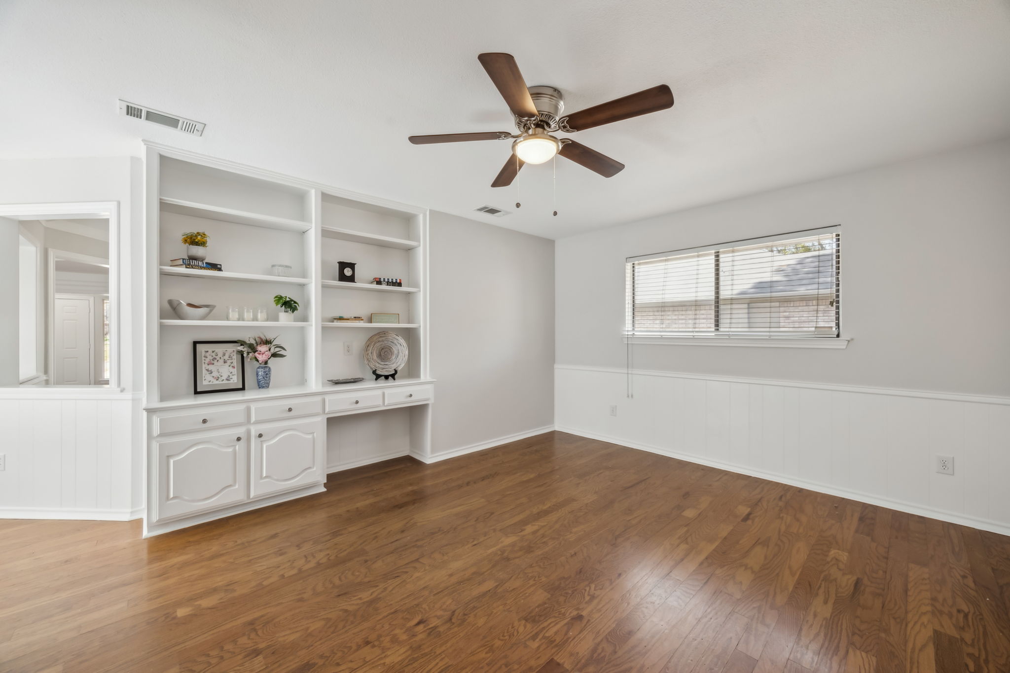And Now... just beyond the breakfast area is the roomy flex room!  Built-in Shelves. Desk area, NEW Ceiling fan and a half bath! - truly the possibilities are endless!