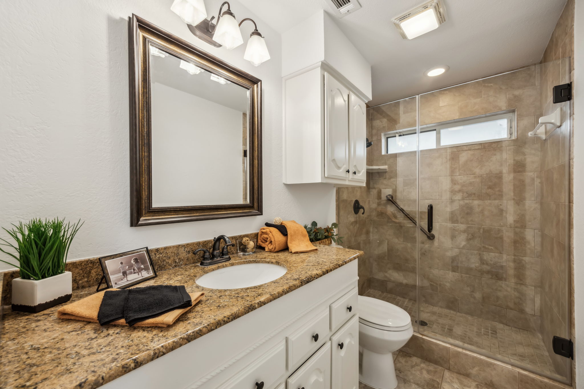 This Impressive Hall Bath also has a designer step in Shower and attractive counter top, mirror and faucet!