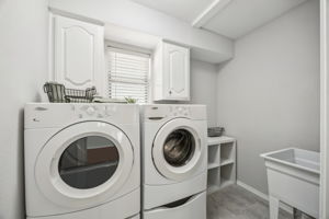 This laundry Room is spacious and includes a sink and storage  as well.  The Washer and Dryer Stay with the home!  Don't miss the New Flooring!