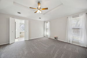 The Master Bedroom !  (All New Carpet) The home has been Professionally painted with a soft gray and accented with lovely white trim!  New Ceiling Fan, too!