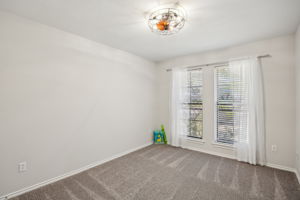 The corner 3rd Bedroom  - also with views of the front - Boasts NEW Carpet, paint and stylish Ceiling Fan!