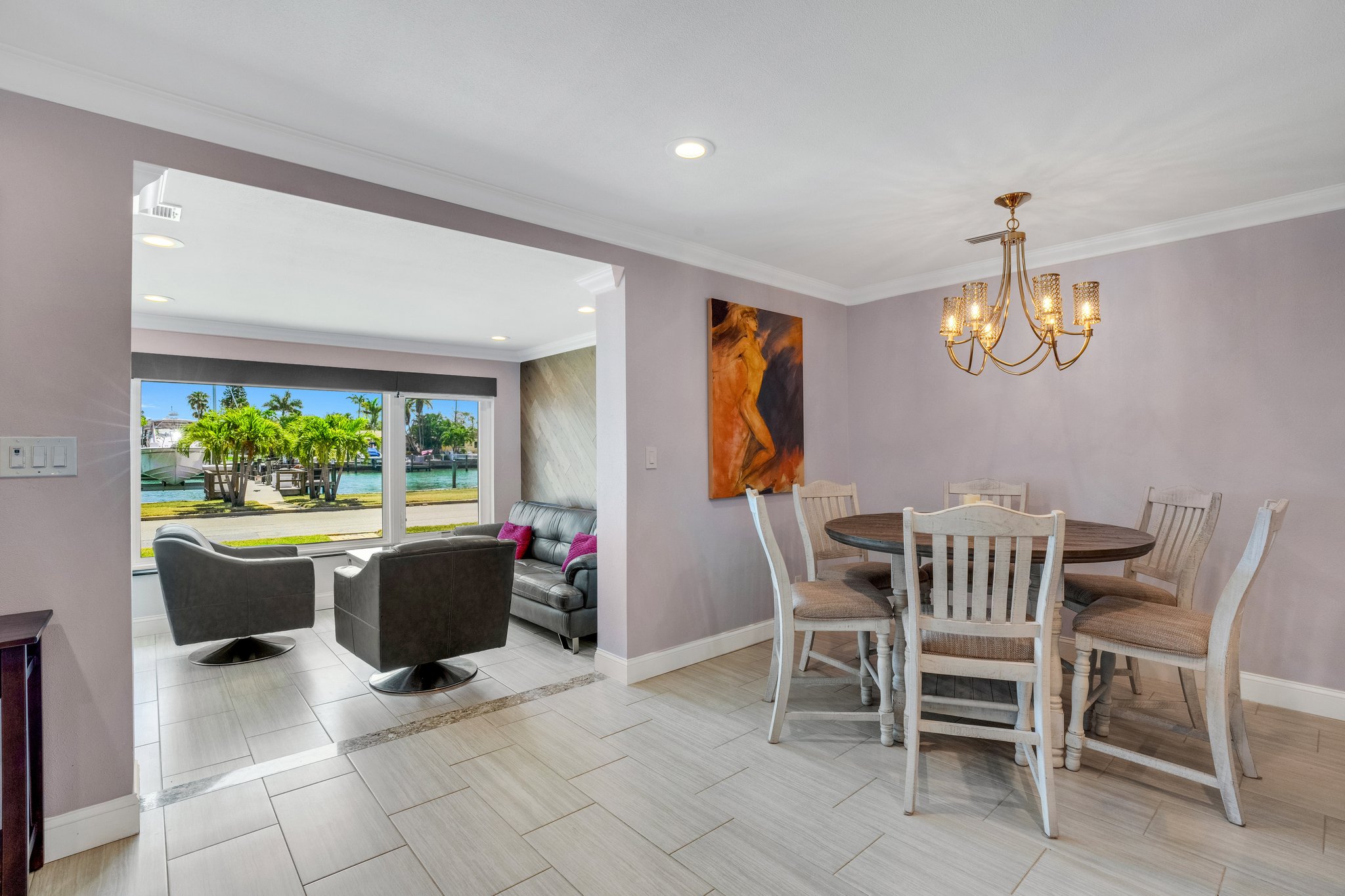 View from Dining Room and Kitchen into Front Sun Room with Waterfront and Dolphin Views