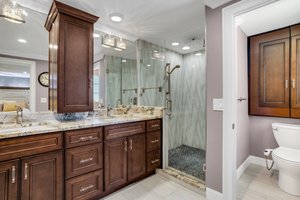 Primary Bathroom with 2 sinks, Stone Countertops, Custom Cabinetry, Oversize Shower