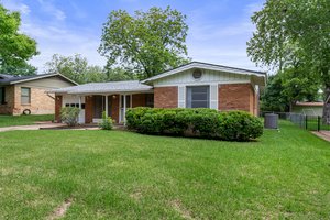 Ranch-style home with brick, 1-car garage.