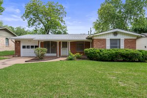 Ranch-style home with brick, 1-car garage.