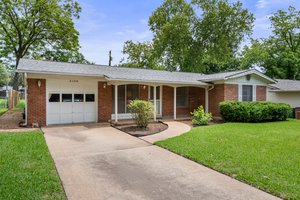 Ranch-style home with brick, 1-car garage.