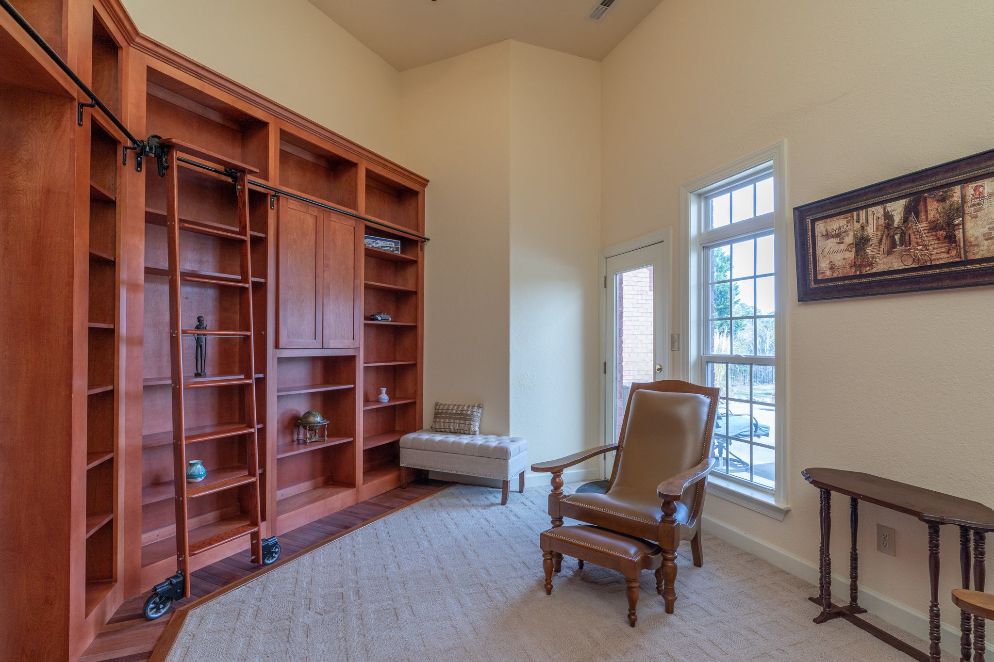 Well appointed library greets visitors at the front door.  Watch the kids swim as you work from home.