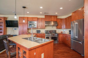 Chefs kitchen with two sinks and large range with pot filler.