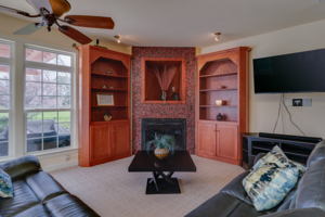 Living room attached to the kitchen, views of the pool and door leading to outside.