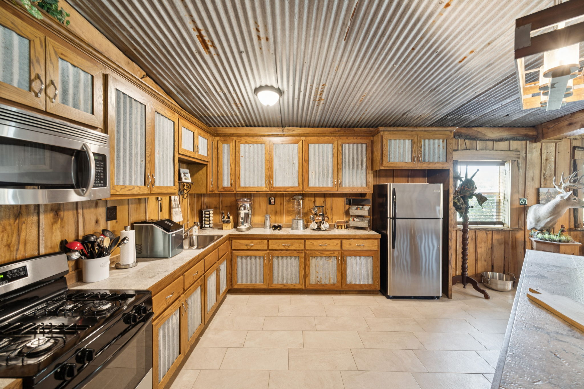 Full kitchen with stainless steel appliances.