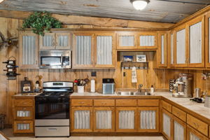 Full kitchen with stainless steel appliances.
