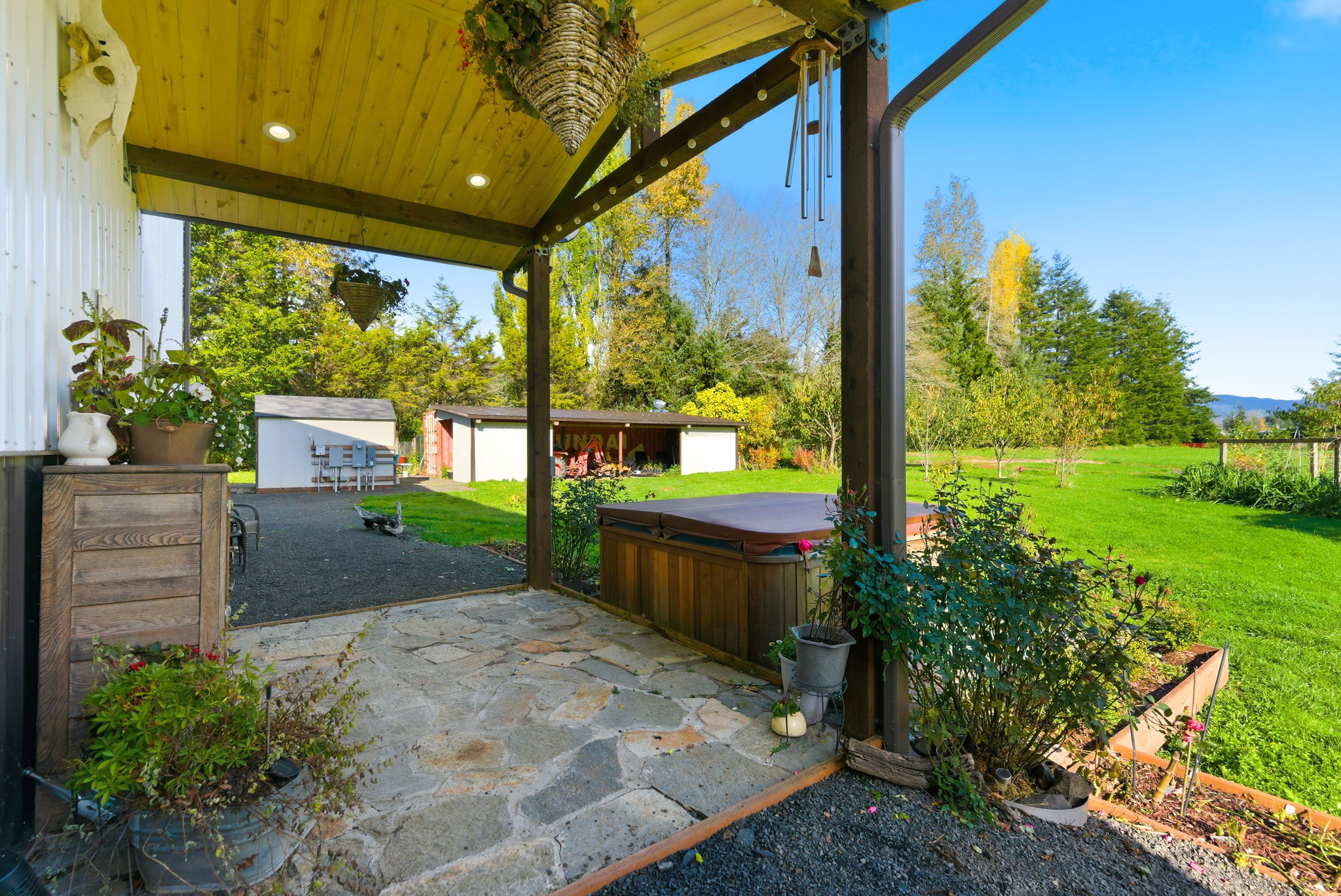 Patio + hot tub, facing outbuildings