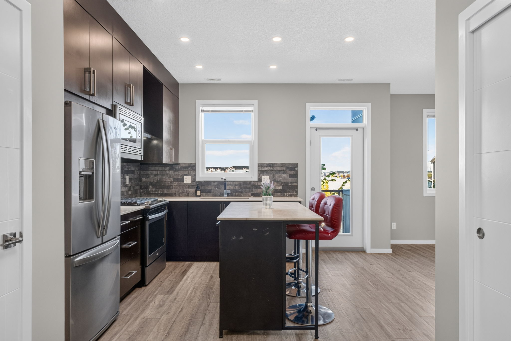 203, 315 Redstone Walk NE, kitchen with a quartz island