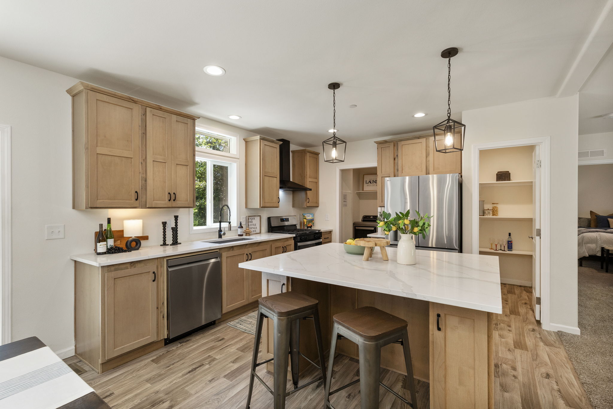 Kitchen with SS appliances, walk in pantry and laundry through the doorway to the left of the fridge.