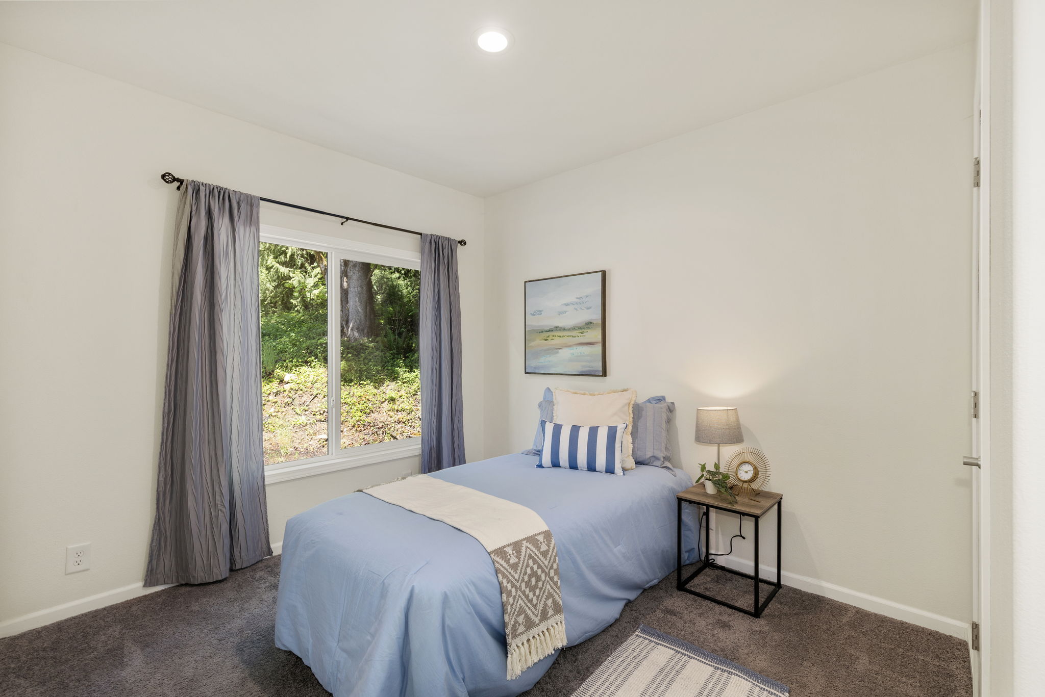Guest bedroom #1 on opposite side of home from primary suite.