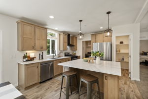Kitchen with SS appliances, walk in pantry and laundry through the doorway to the left of the fridge.