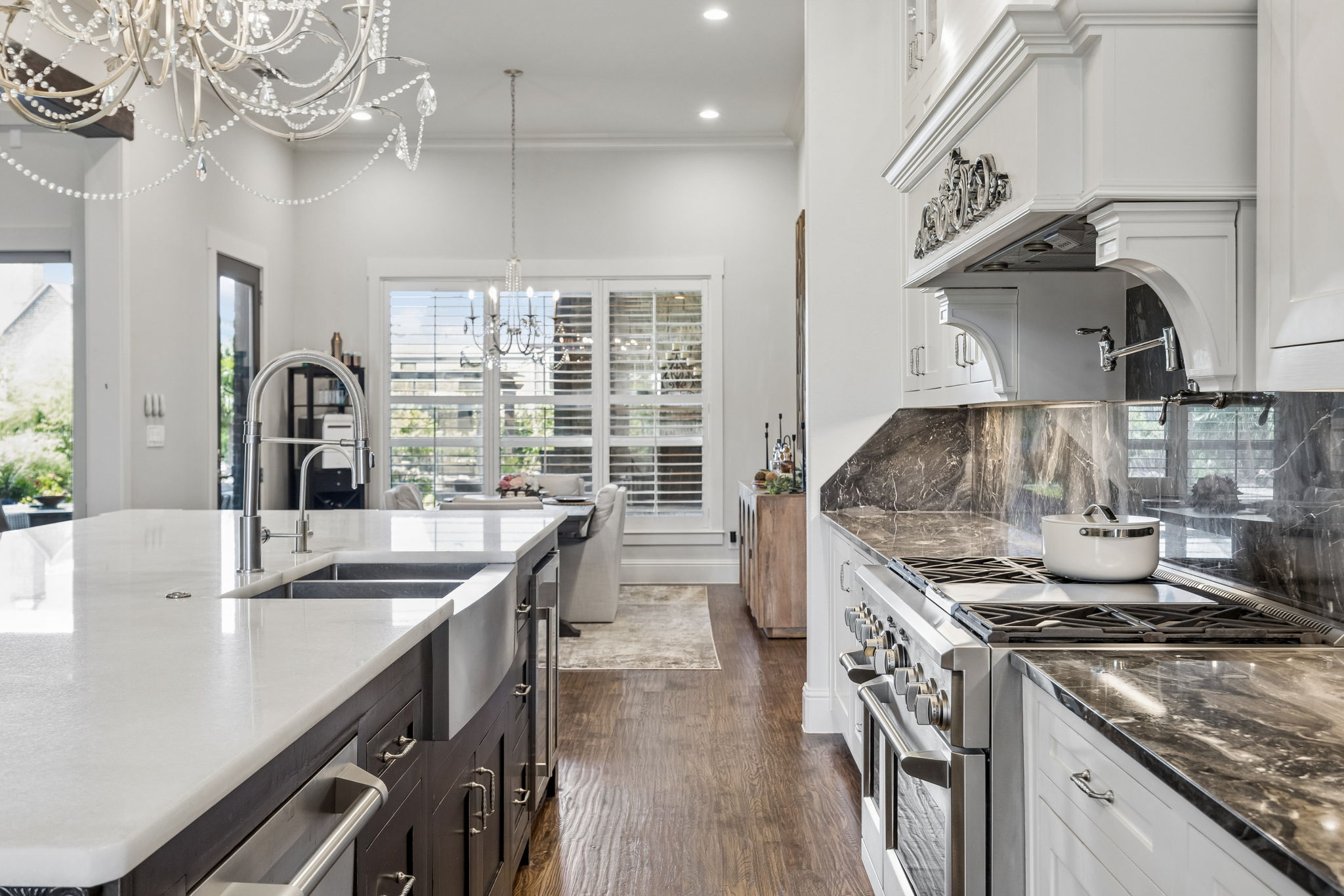 Designed for Efficient Meal Preparation – The generous work aisle places the professional range, sink, island storage, and nearby dining area within easy reach, making the kitchen practical for both everyday meals and larger events.
