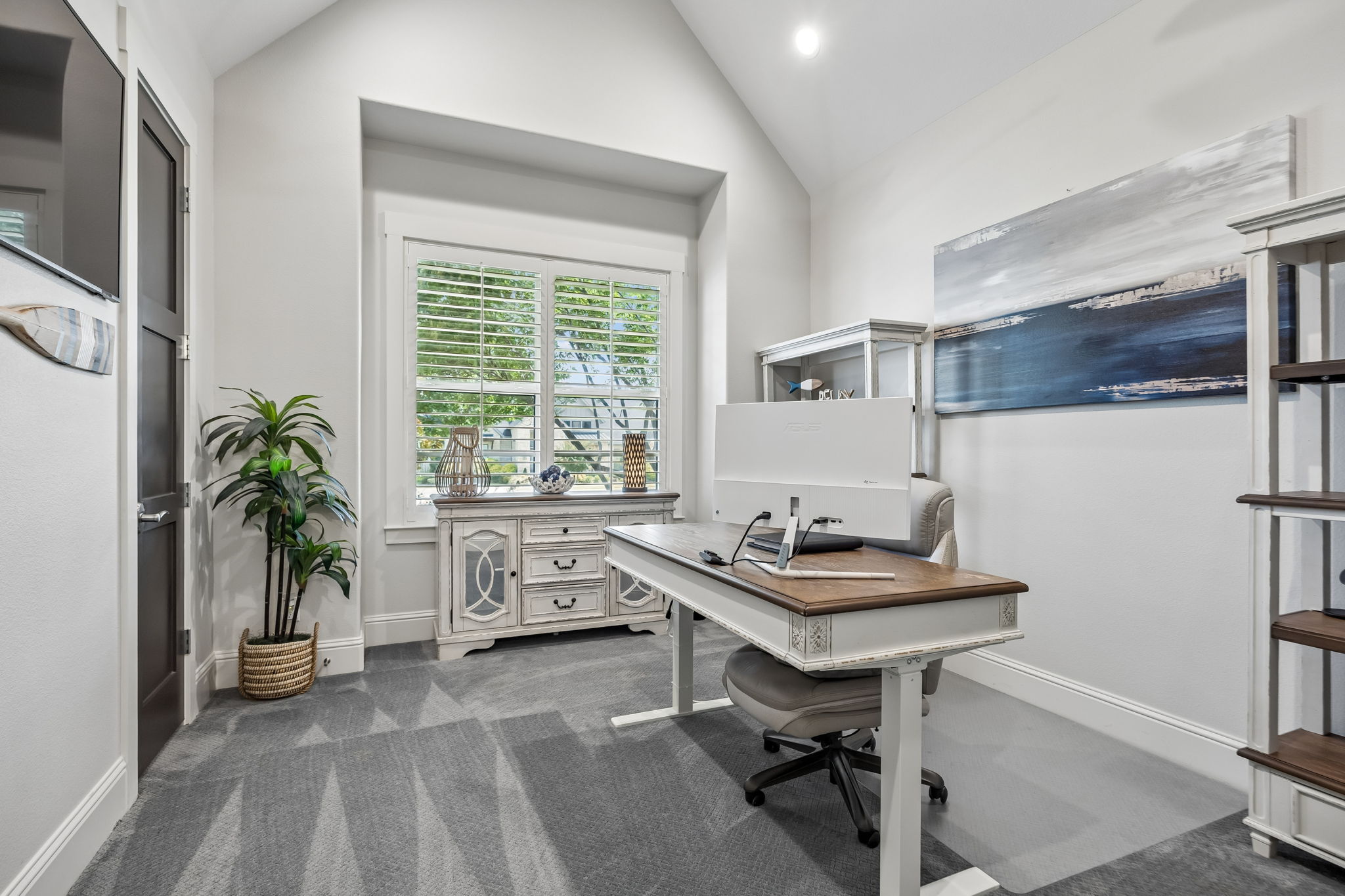 A Flexible Private Workspace – This secondary office offers a vaulted ceiling, natural light, and separation from the home’s main gathering spaces, making it well suited for focused work, study, hobbies, or creative use.