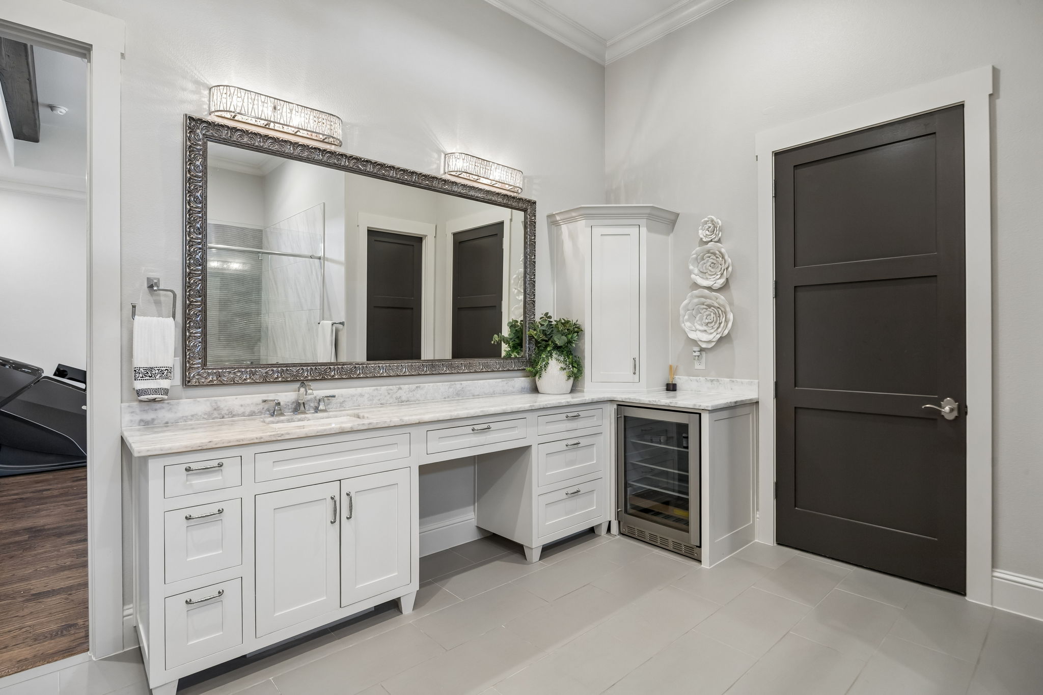 A Dedicated Getting-Ready Station – This extended vanity includes generous counter space, abundant storage, a seated grooming area, and a built-in beverage cooler for added convenience within the primary suite.