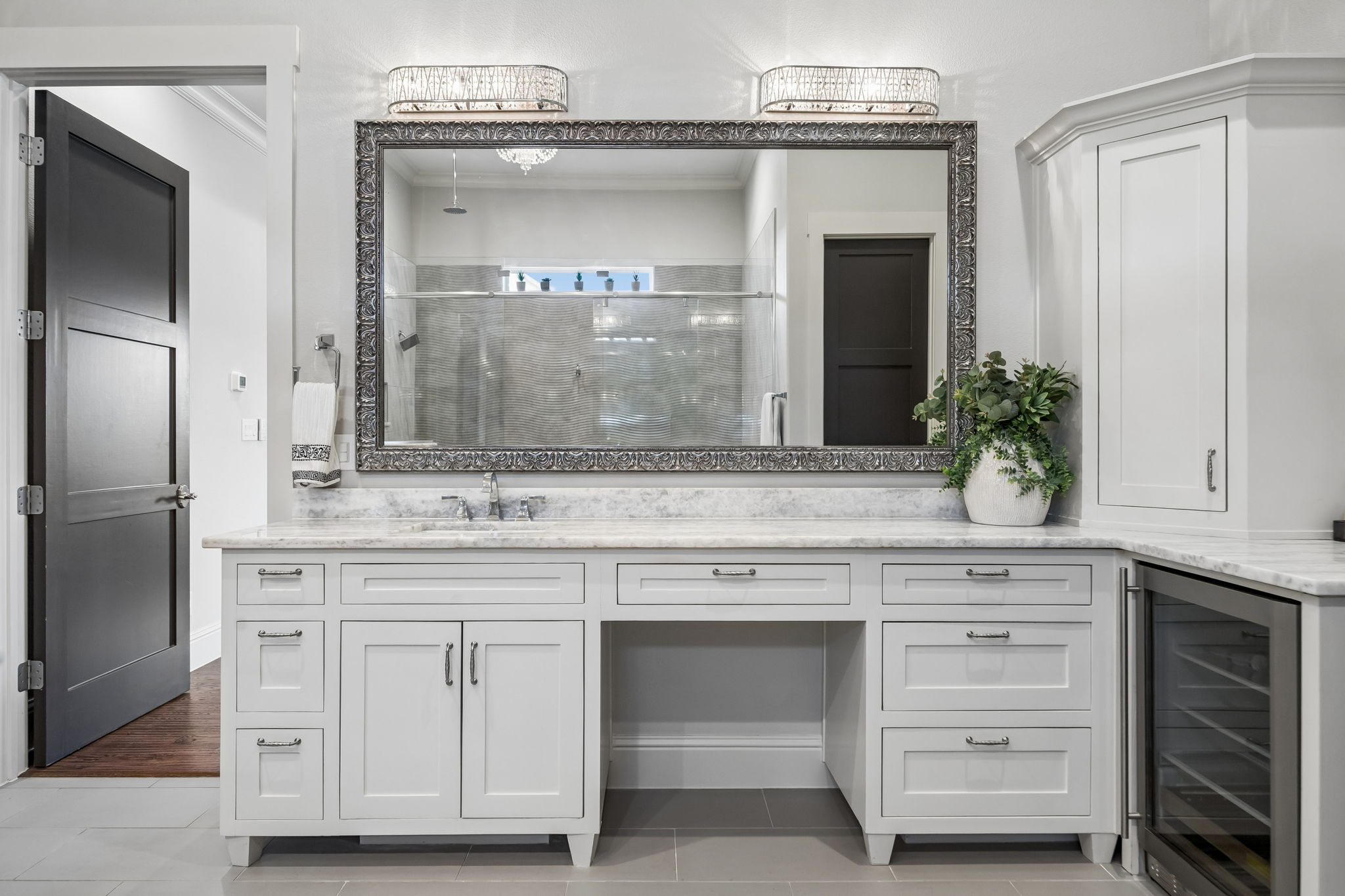 Custom Cabinetry Throughout the Primary Bath – The long vanity, integrated storage tower, quartz counters, and broad mirror offer a polished combination of organization, function, and visual impact.
