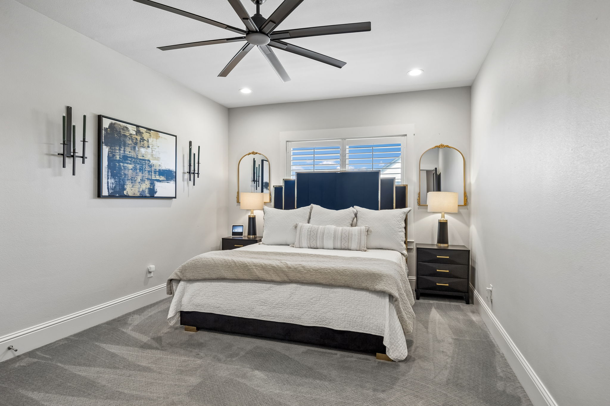 A Comfortable Upstairs Bedroom – This secondary bedroom offers a well-proportioned layout, a wide window, recessed lighting, and enough wall space for flexible furniture placement.