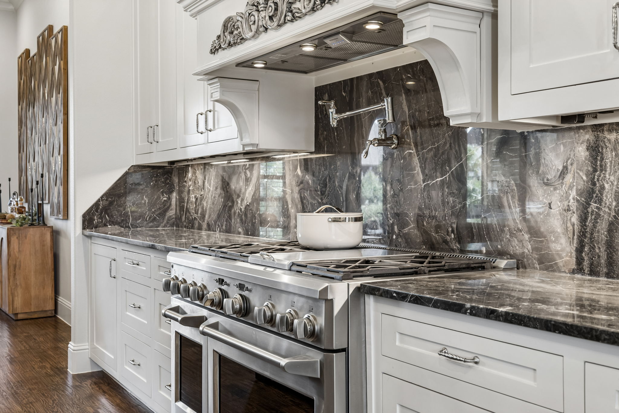 Professional-Grade Cooking Power – The 48-inch GE Monogram gas range, double ovens, pot filler, substantial vent hood, and expansive stone work surfaces support everything from weeknight meals to large-scale entertaining.