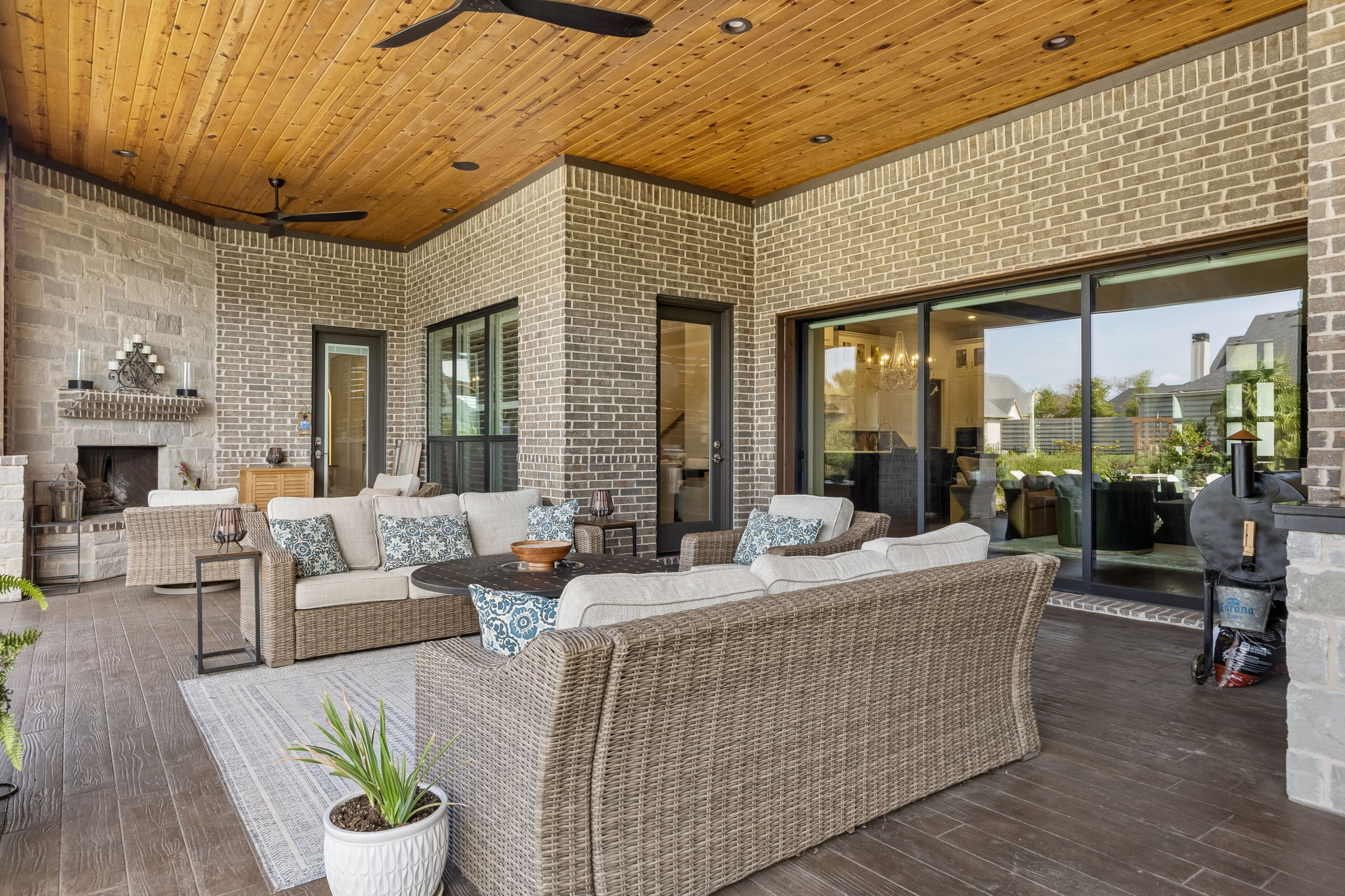 A True Extension of the Great Room – The covered terrace is wide enough for multiple seating zones and connects directly to the interior through the large glass opening, making indoor-outdoor gatherings feel seamless.