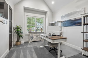 A Flexible Private Workspace – This secondary office offers a vaulted ceiling, natural light, and separation from the home’s main gathering spaces, making it well suited for focused work, study, hobbies, or creative use.