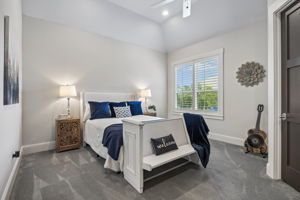 Comfortable Accommodations – This well-proportioned bedroom features a vaulted ceiling, a large window, and ample floor space, creating a bright and comfortable private retreat.