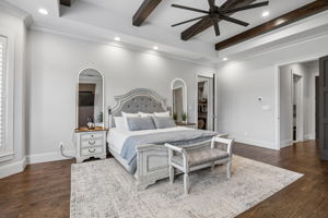 Architectural Detail Above – Dark exposed beams, recessed lighting, and a large ceiling fan add depth and character to the tray ceiling while emphasizing the scale of the primary bedroom.