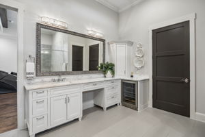 A Dedicated Getting-Ready Station – This extended vanity includes generous counter space, abundant storage, a seated grooming area, and a built-in beverage cooler for added convenience within the primary suite.