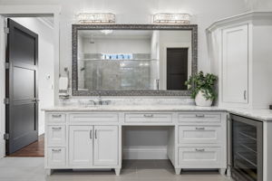 Custom Cabinetry Throughout the Primary Bath – The long vanity, integrated storage tower, quartz counters, and broad mirror offer a polished combination of organization, function, and visual impact.