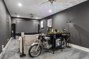 A Private Media Room for Movie Nights – Dark walls and controlled lighting create an immersive setting for films, sports, gaming, and streaming.