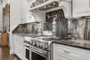 Professional-Grade Cooking Power – The 48-inch GE Monogram gas range, double ovens, pot filler, substantial vent hood, and expansive stone work surfaces support everything from weeknight meals to large-scale entertaining.