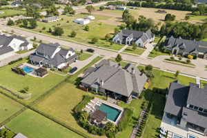 A Well-Placed Backyard Retreat – The pool and pergola sit behind the home with surrounding lawn and landscaping, creating a defined outdoor destination without overwhelming the property.