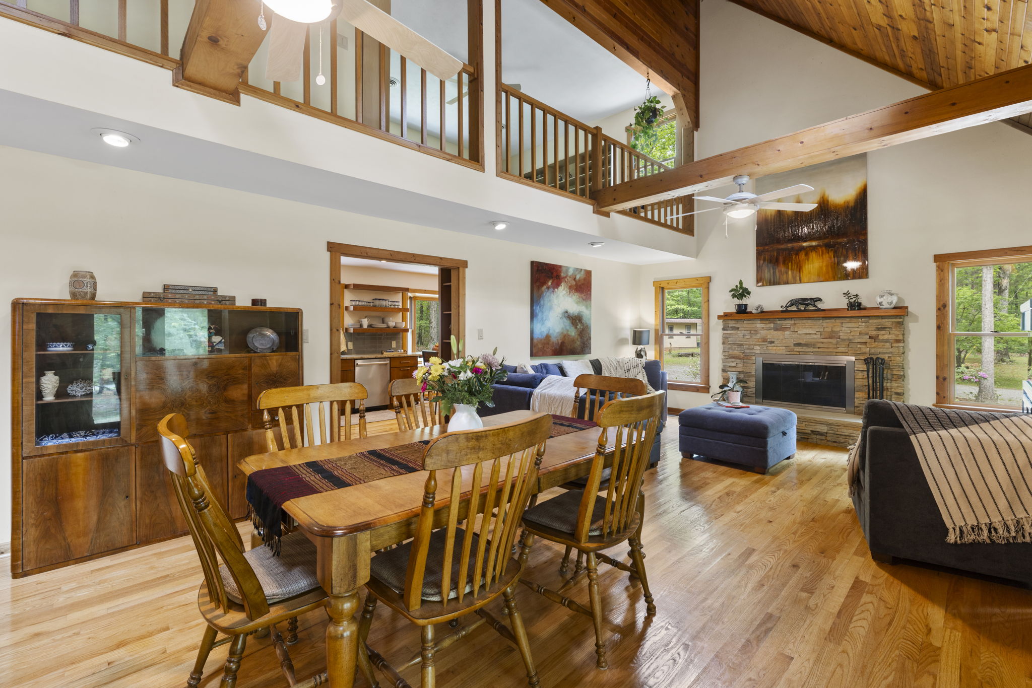 The open great room greets you as you enter the front door with lofted ceilings & exposed beams.