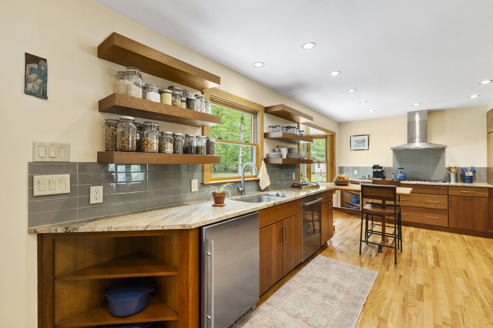 Large kitchen with hardwood floors & recessed can lighting.