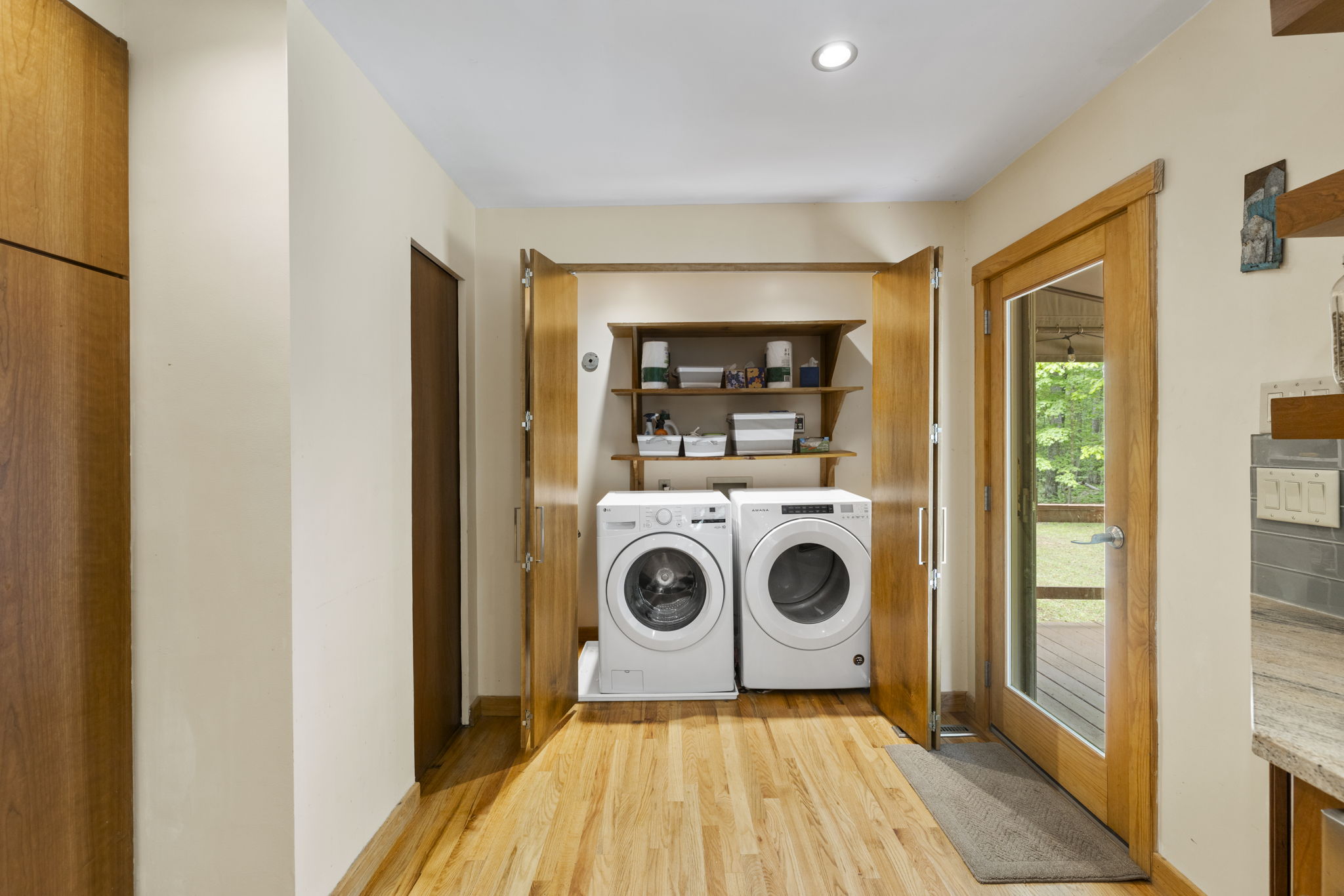 Laundry closet with shelf storage.