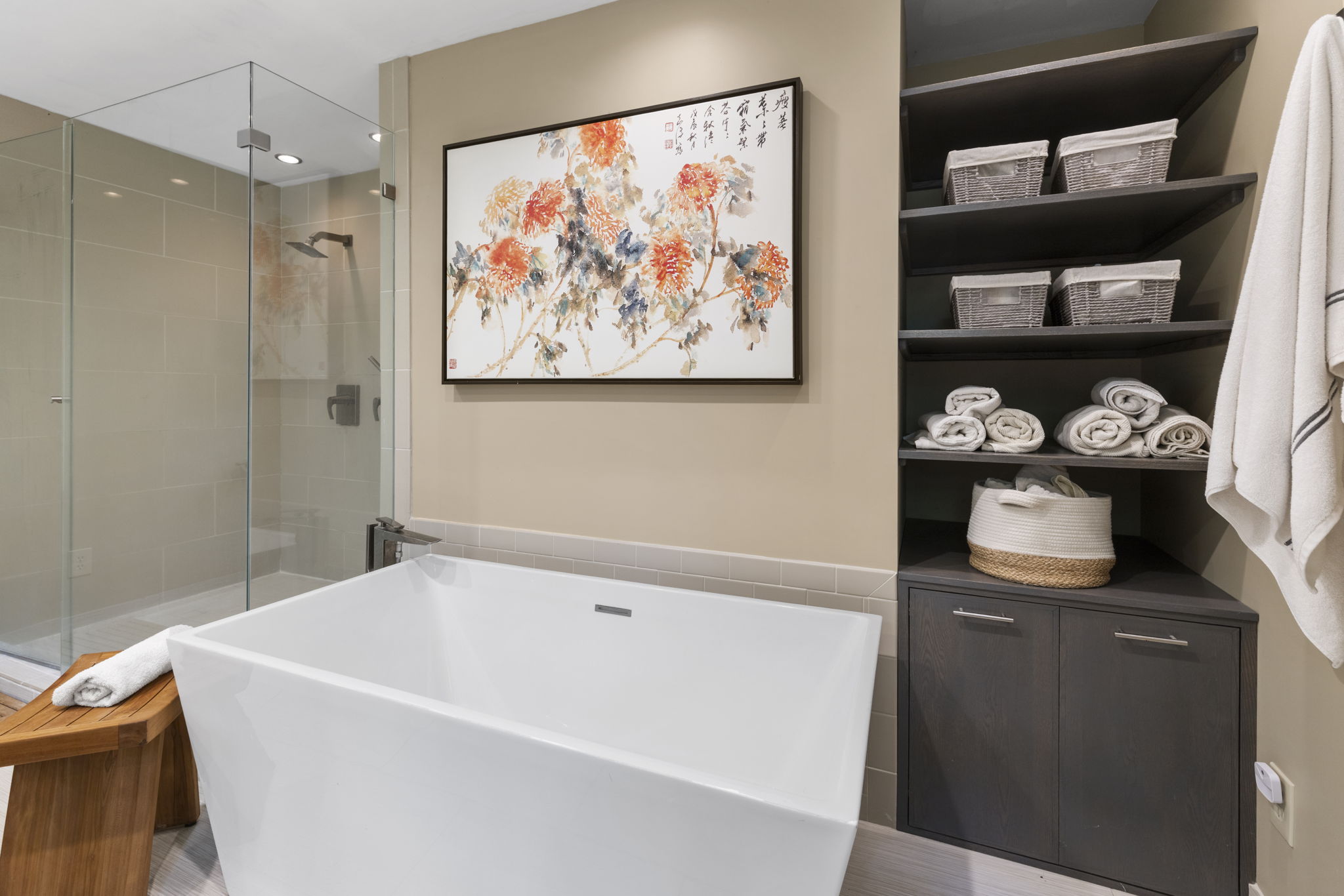 Beautiful soaking tub & built in shelf & cabinet storage in primary bathroom.