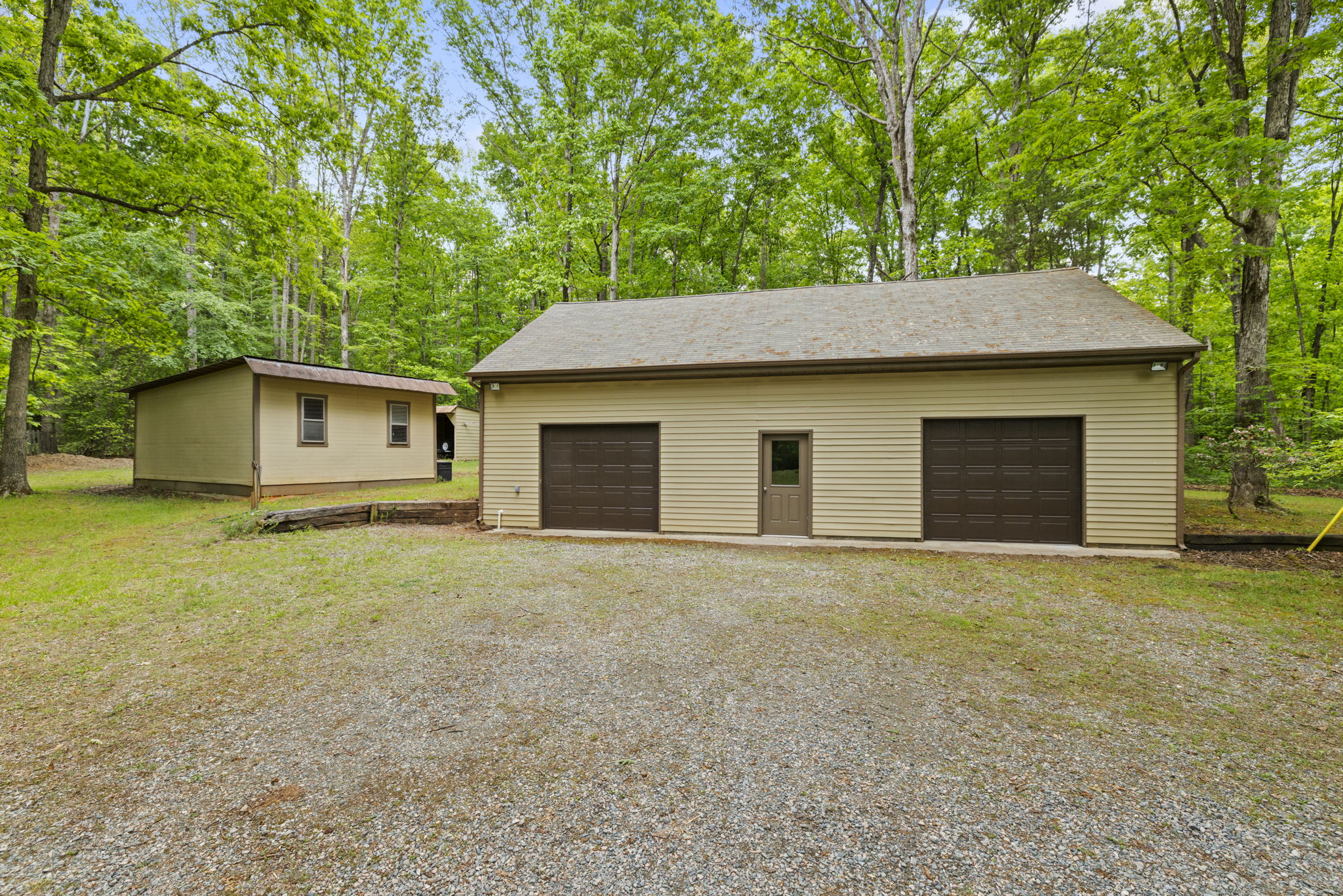 Detached garage with finished space on 2nd floor, new garage doors (2025), and newer windows (2011).