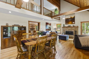 The open great room greets you as you enter the front door with lofted ceilings & exposed beams.