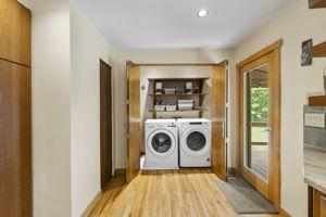 Laundry closet with shelf storage.