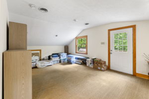Sisel rug/carpeting in finished 2nd floor of garage with a direct exterior entrance, closet space, & potential space for a full bathroom.