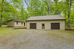 Detached garage with finished space on 2nd floor, new garage doors (2025), and newer windows (2011).