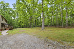 Huge yard with plenty of open space and surrounded by mature trees for wonderful privacy and wooded views.