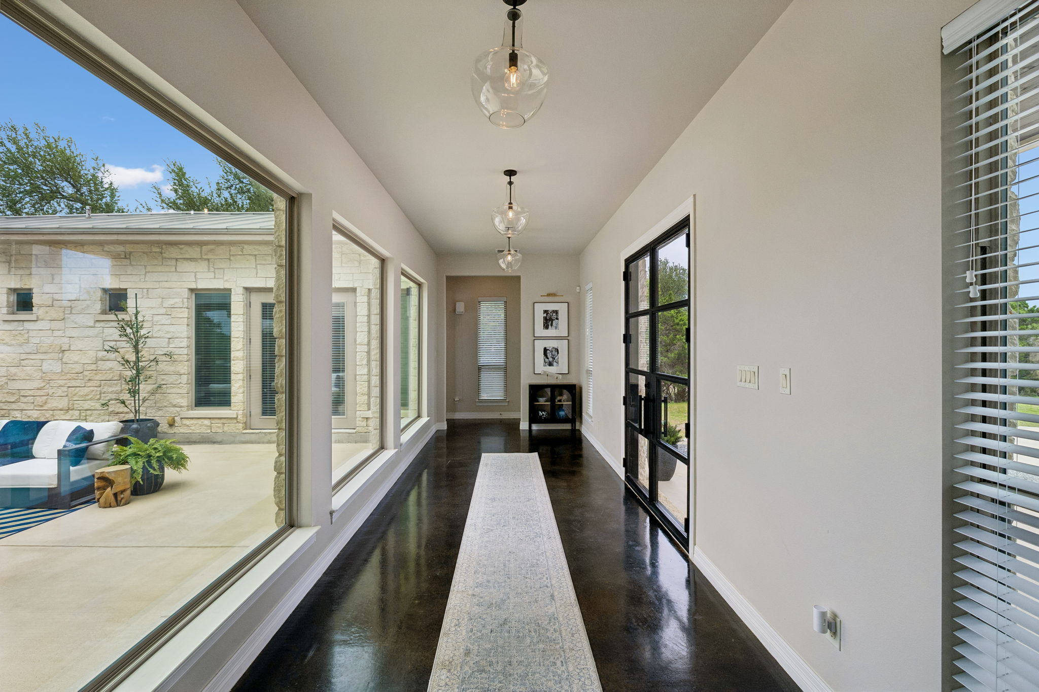 Floor to ceiling windows greet you as you enter the home.