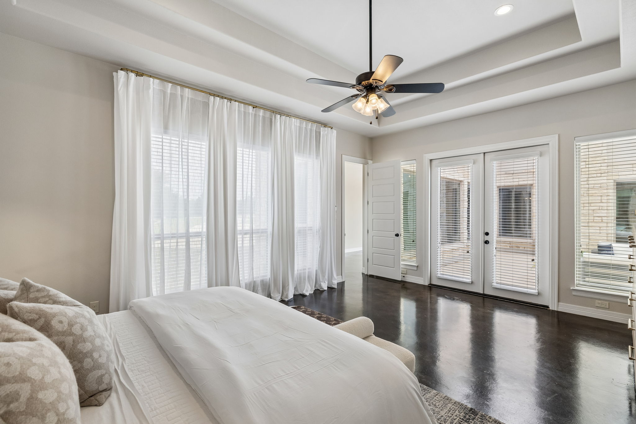 Primary bedroom suite with coffered ceilings, with a private entrance to the pool.