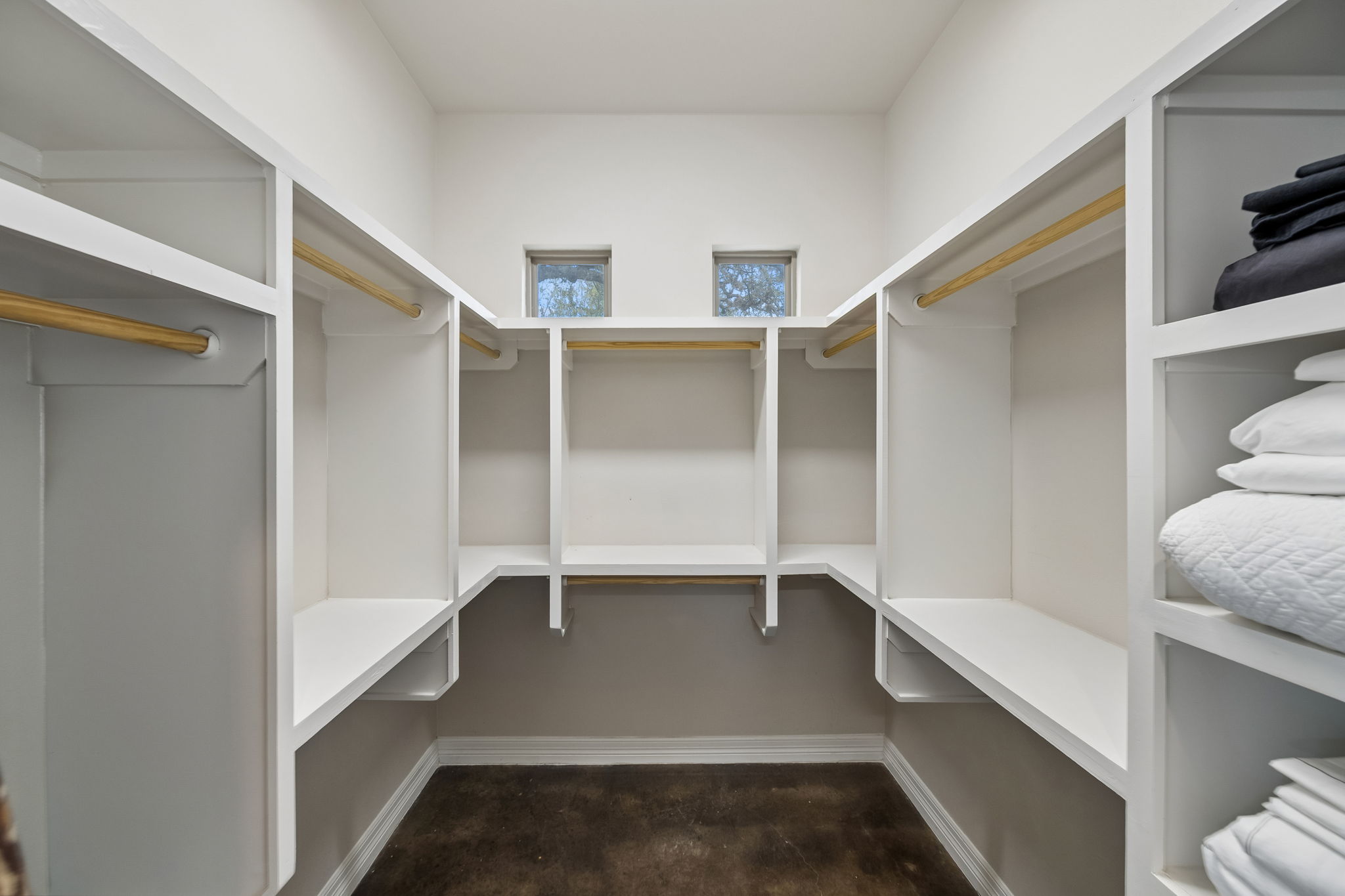 Second of two primary walk-in closets for him and her.