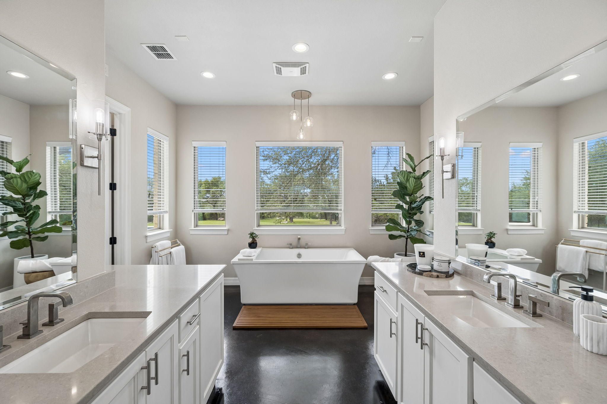 Primary bathroom with separate vanities.